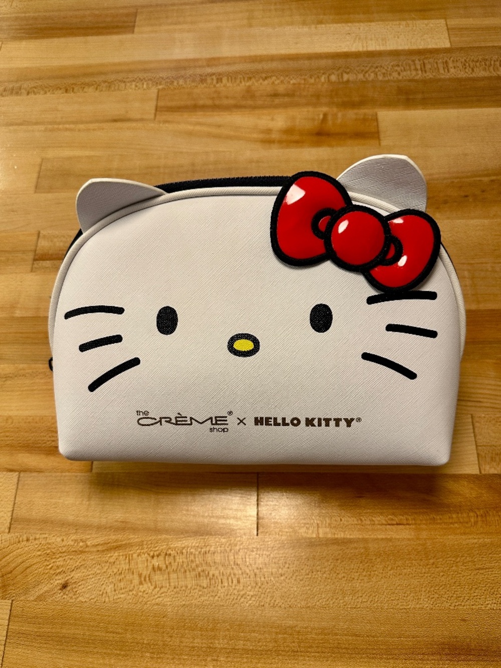 The Creme Shop x Hello Kitty zip makeup travel bag: white w/red bow/yellow nose